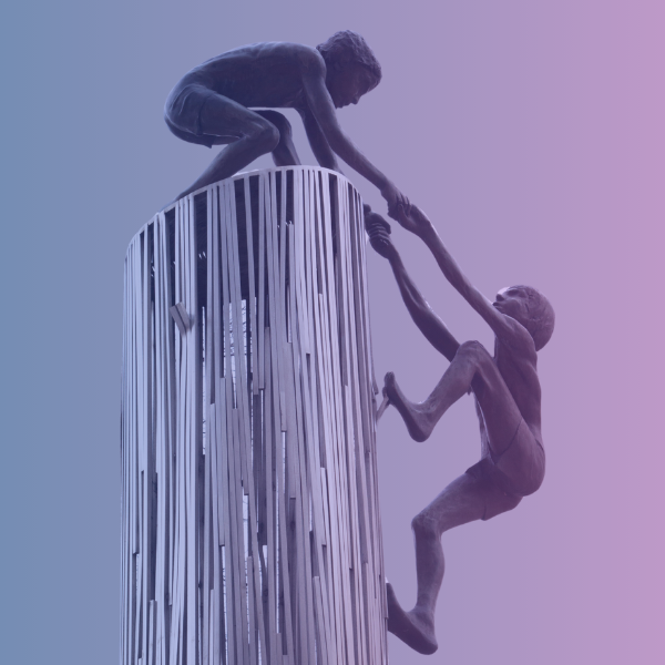 A close-up of a sculpture titled 'Man Helping Man.' A person is climbing up the side of a column and is holding hands with another person standing on top of the column, helping to pull the first person up.