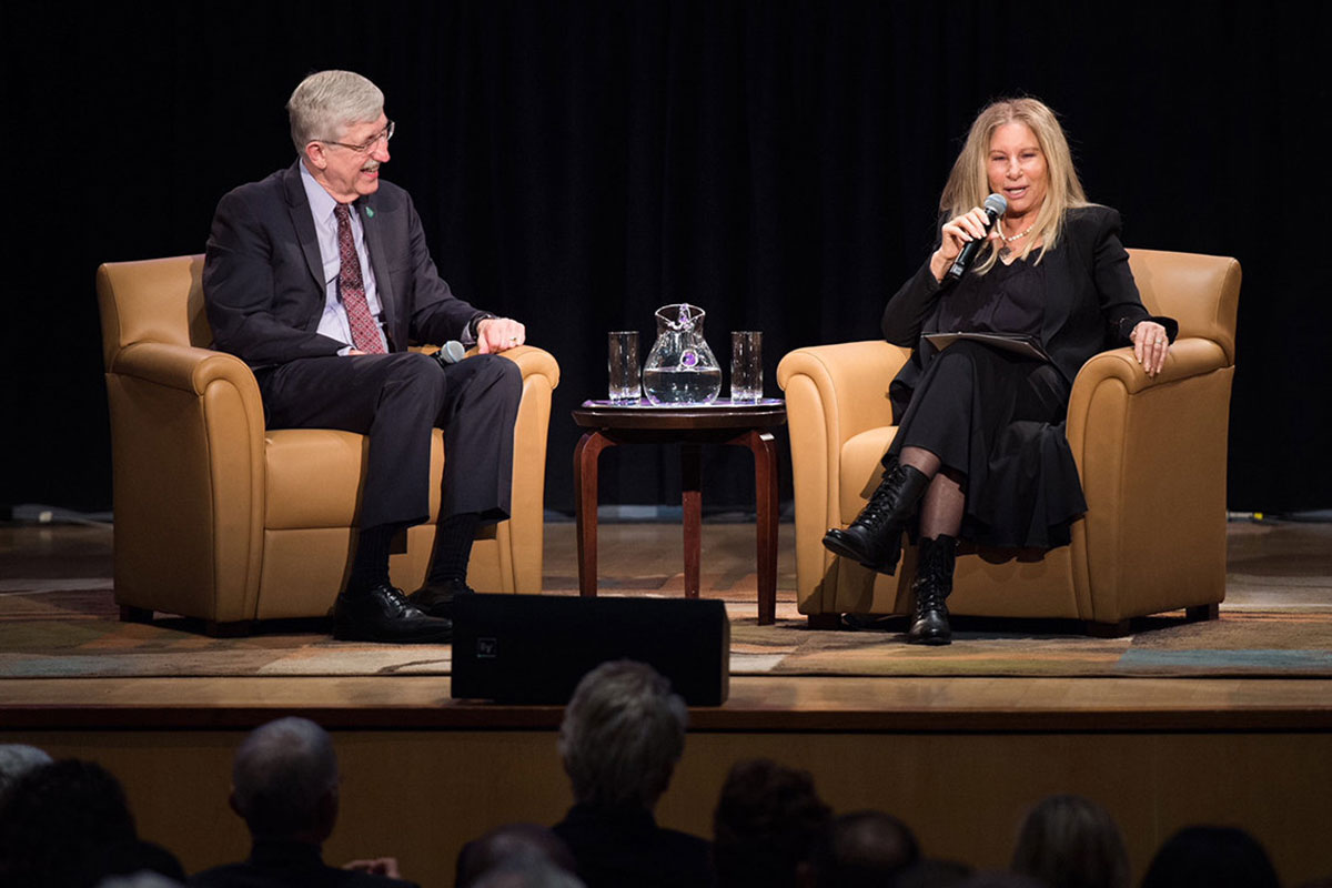 NIH director Dr. Francis Collins chats with Streisand on the stage of a packed Kirschstein Auditorium. CREDIT: WOMEN'S HEART ALLIANCE